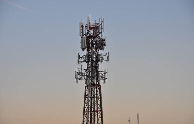 cell tower against sunset sky